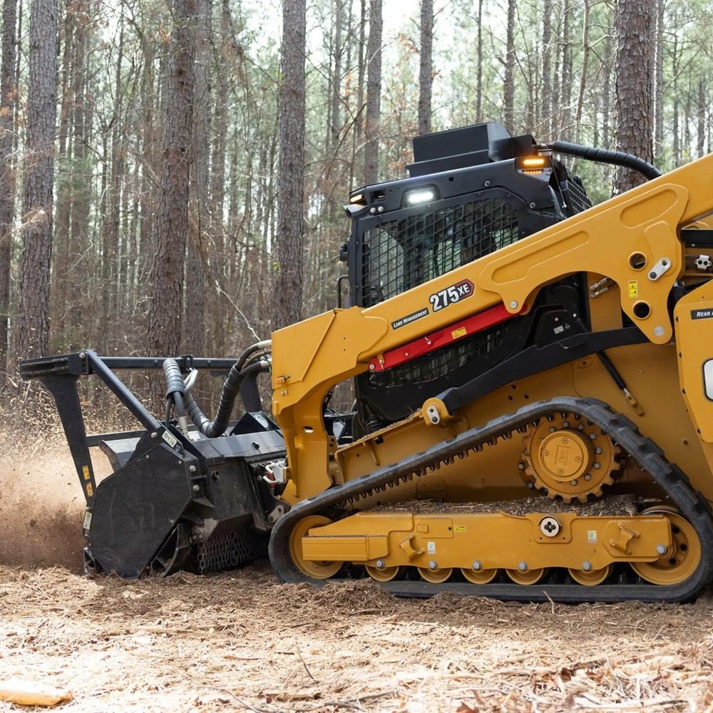 Operator using specialized equipment to clear thick brush around uneven Florida terrain safely